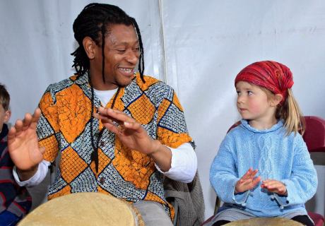 Uche Gabriel Akujobi leads the African drumming workshop helped along by Sally North (4) at the Irish Aid tent, Africa Day 2014