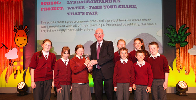 Lyreacrompe NS, Co Kerry receiving their throphy from the Minister for Foerign Affairs and Trade, Charlie Flanagan at the Our World Awards finals