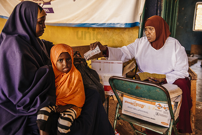 Idle Abdi Mohammed is given her weekly supply of Plumpy Sup for her daughter Zaynab by the nutritionist at Bula Hawa MCH. Credit: Amunga Eshuchi/Trocaire